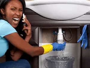 Emergency plumbing repair for a leaking sink drain under a bathroom vanity in Reno, NV