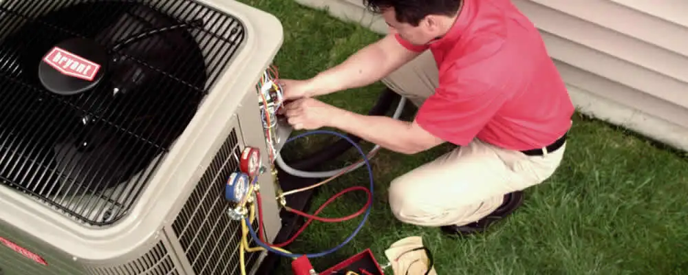 HVAC technician servicing an outdoor air conditioner unit in Reno, NV