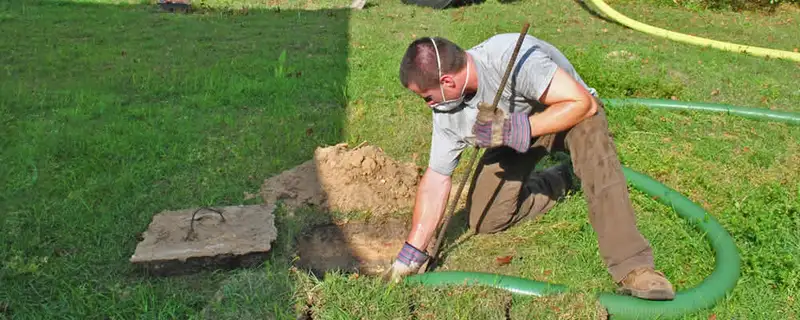 Septic pumping technician servicing a residential septic tank in Reno, NV